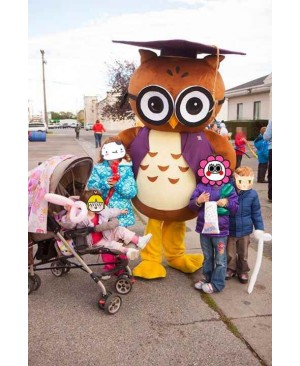 Round Brown and White Owl Mascot Costume with a Purple Graduation Cap